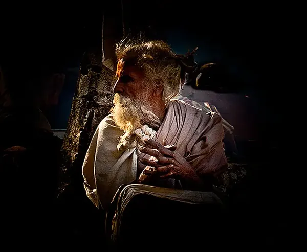 A sadhu at Parasuram Kund, lit against the dark